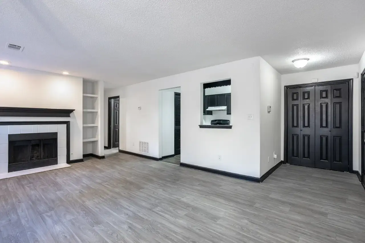 Two-bedroom living room with a fireplace and built-in shelves