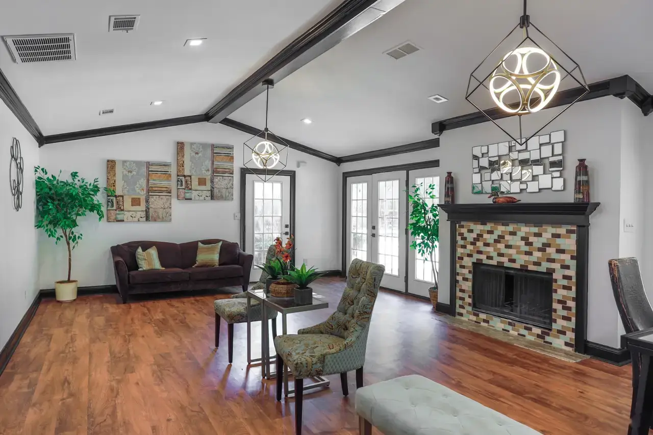 Clubhouse lounge with a tiled fireplace, vaulted ceiling and seating